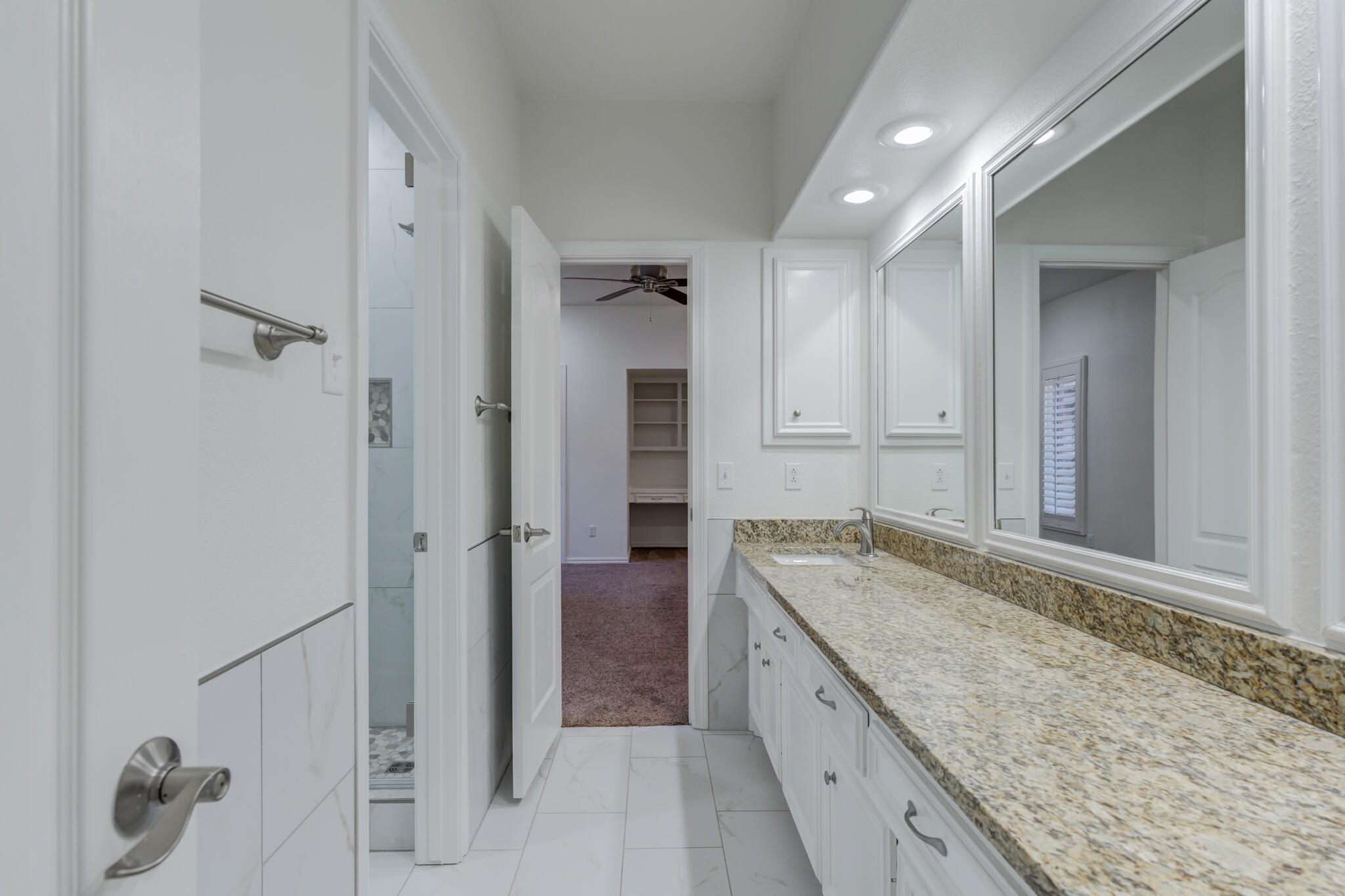 4707 85th Street Lubbock, TX 79424 - Photo 49 of 63 a spacious bathroom with a granite countertop sink and a mirror