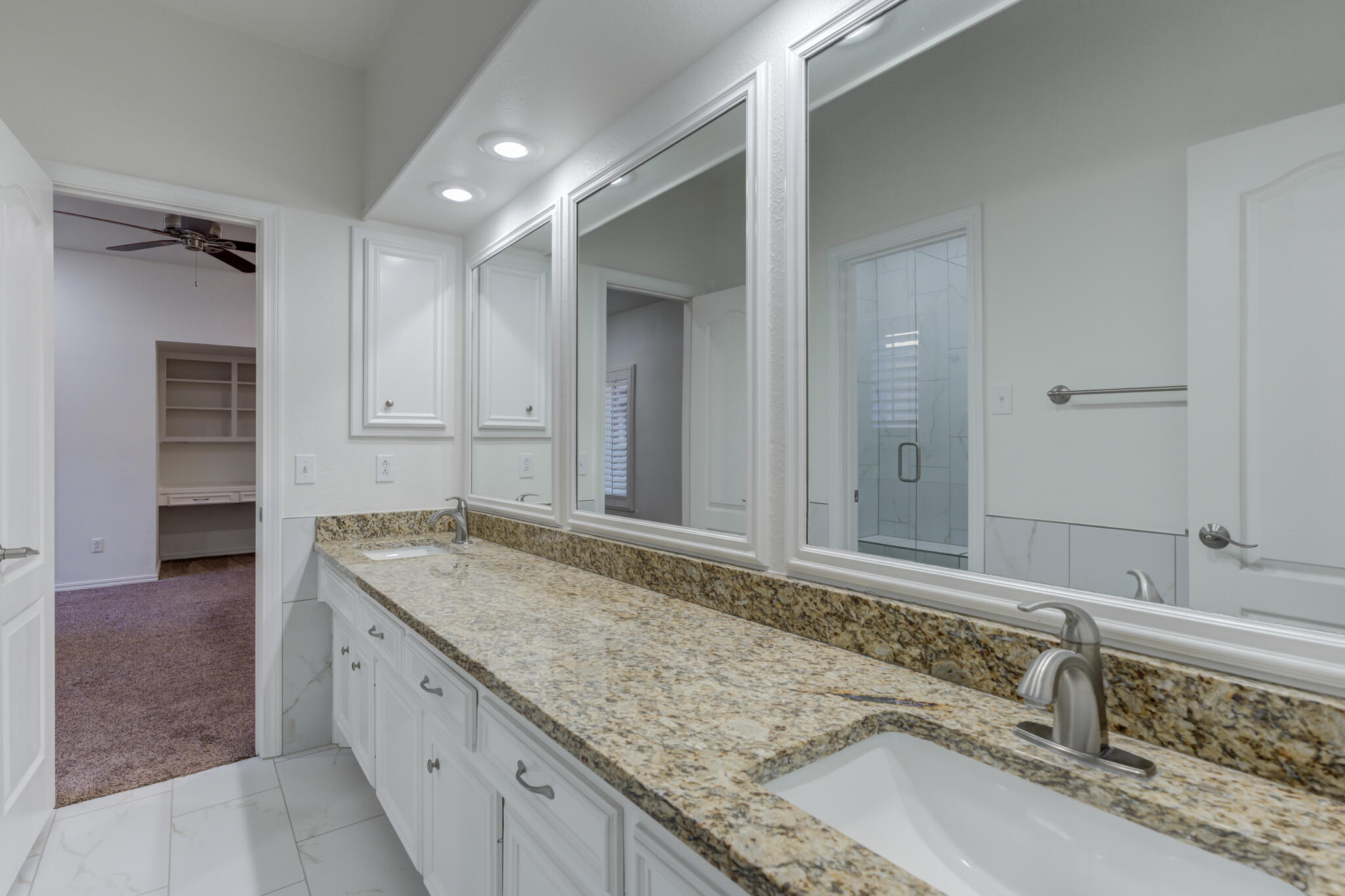 4707 85th Street Lubbock, TX 79424 - Photo 50 of 63 a bathroom with a granite countertop sink and a mirror