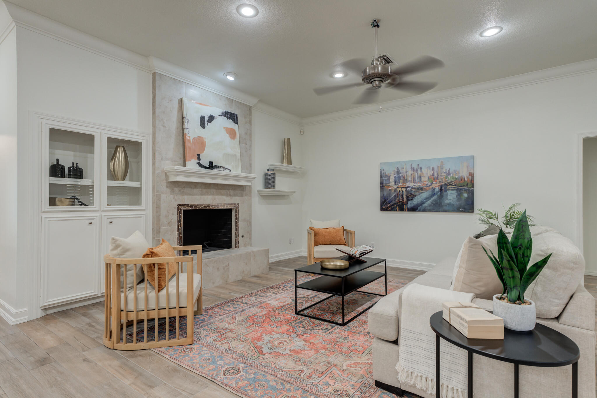 4707 85th Street Lubbock, TX 79424 - Photo 9 of 63 a living room with furniture a fireplace and a potted plant