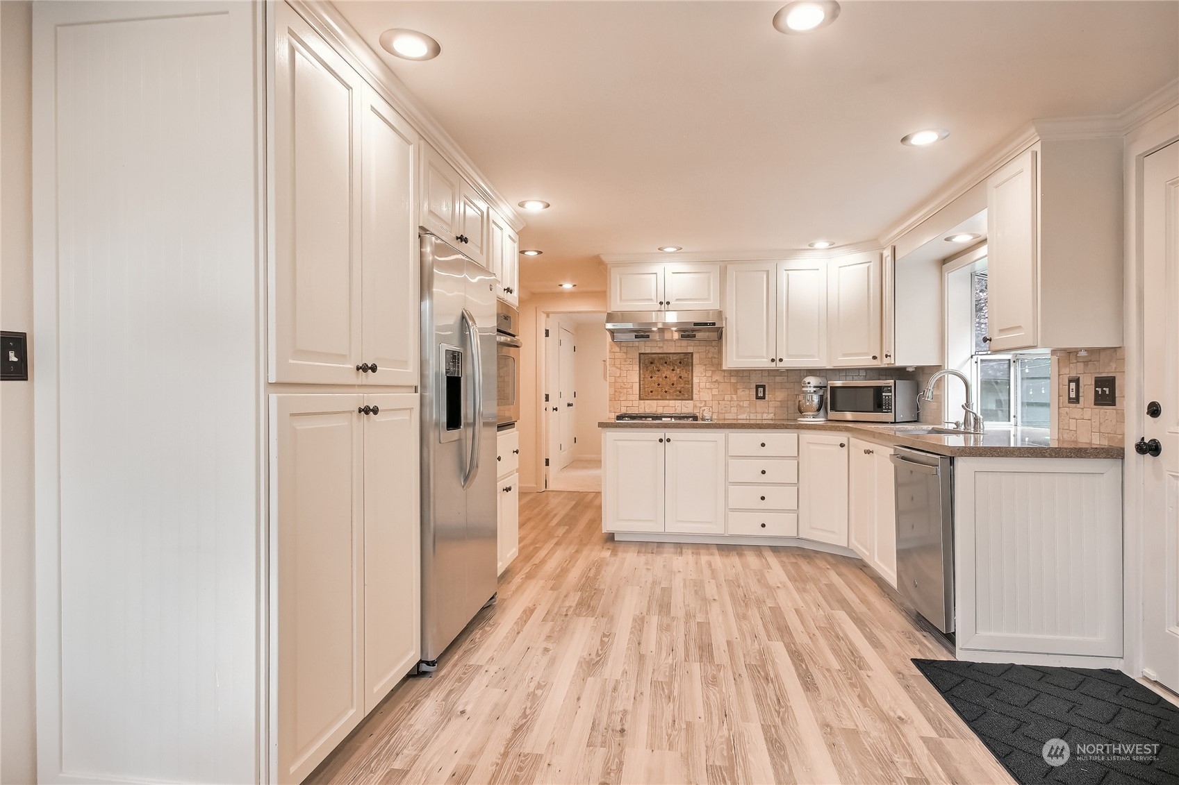 31 213th Street Southwest Bothell, WA 98021 - Photo 11 of 40 a kitchen with a refrigerator a sink and white cabinets