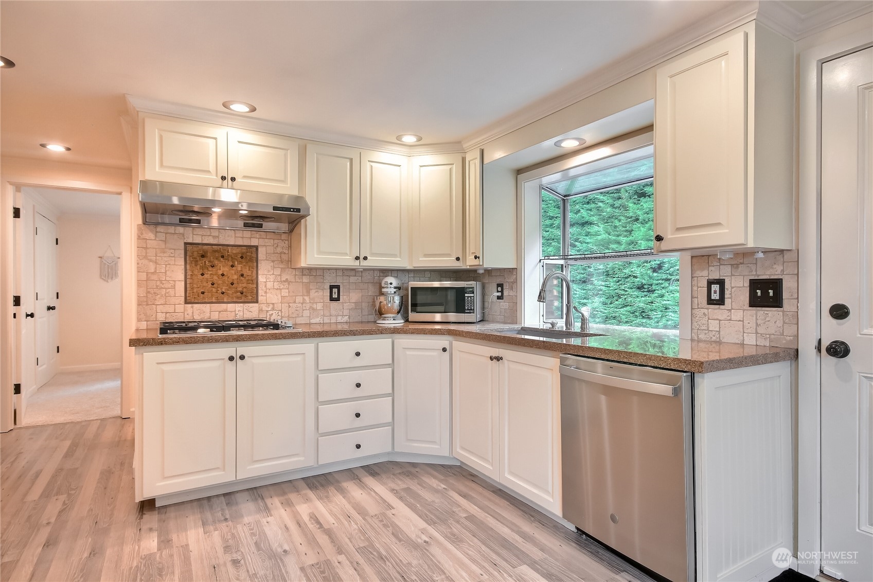 31 213th Street Southwest Bothell, WA 98021 - Photo 12 of 40 a kitchen with stainless steel appliances granite countertop a stove a sink and white cabinets with wooden floor