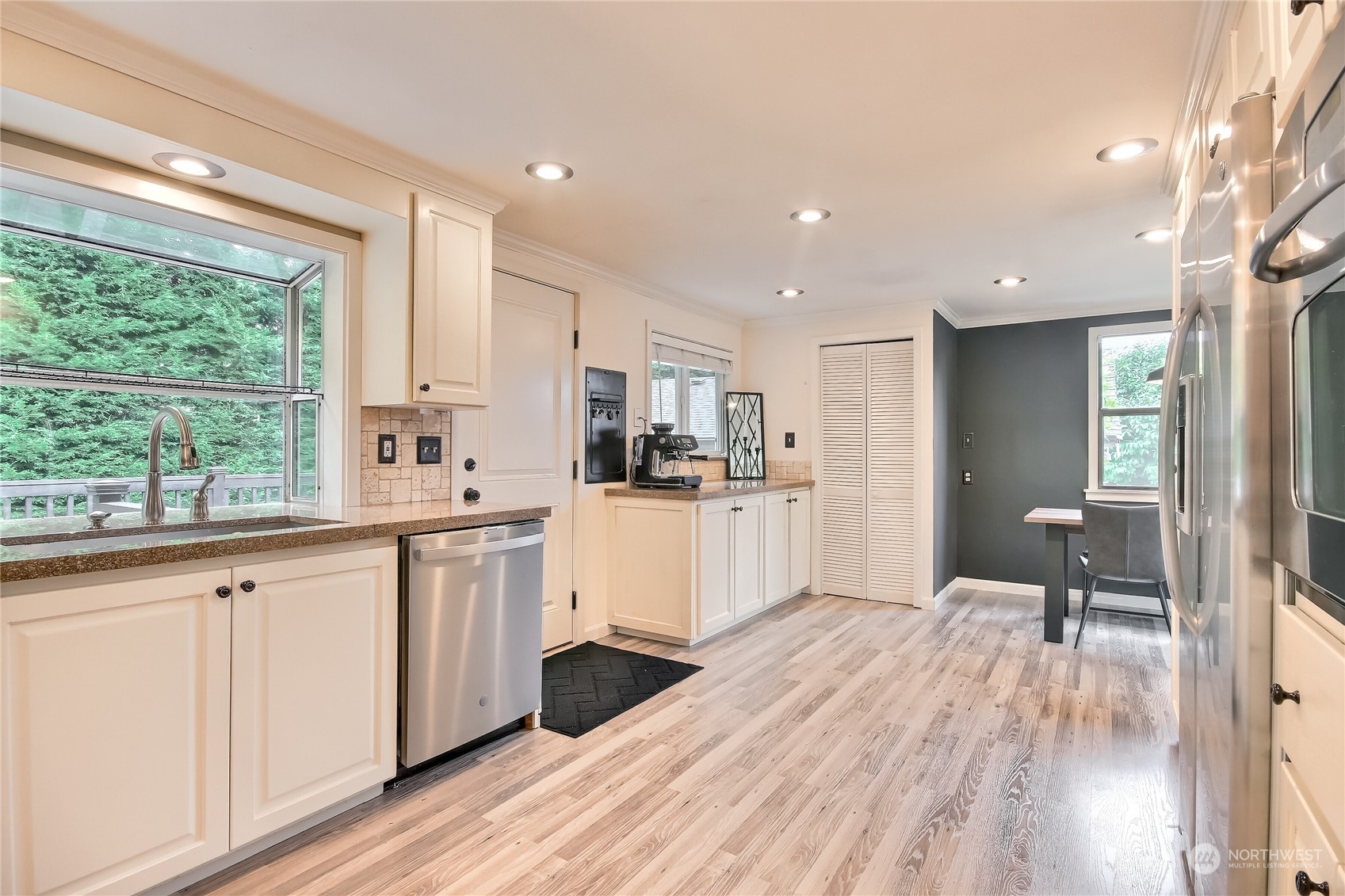 31 213th Street Southwest Bothell, WA 98021 - Photo 14 of 40 a kitchen with white cabinets and wooden floor