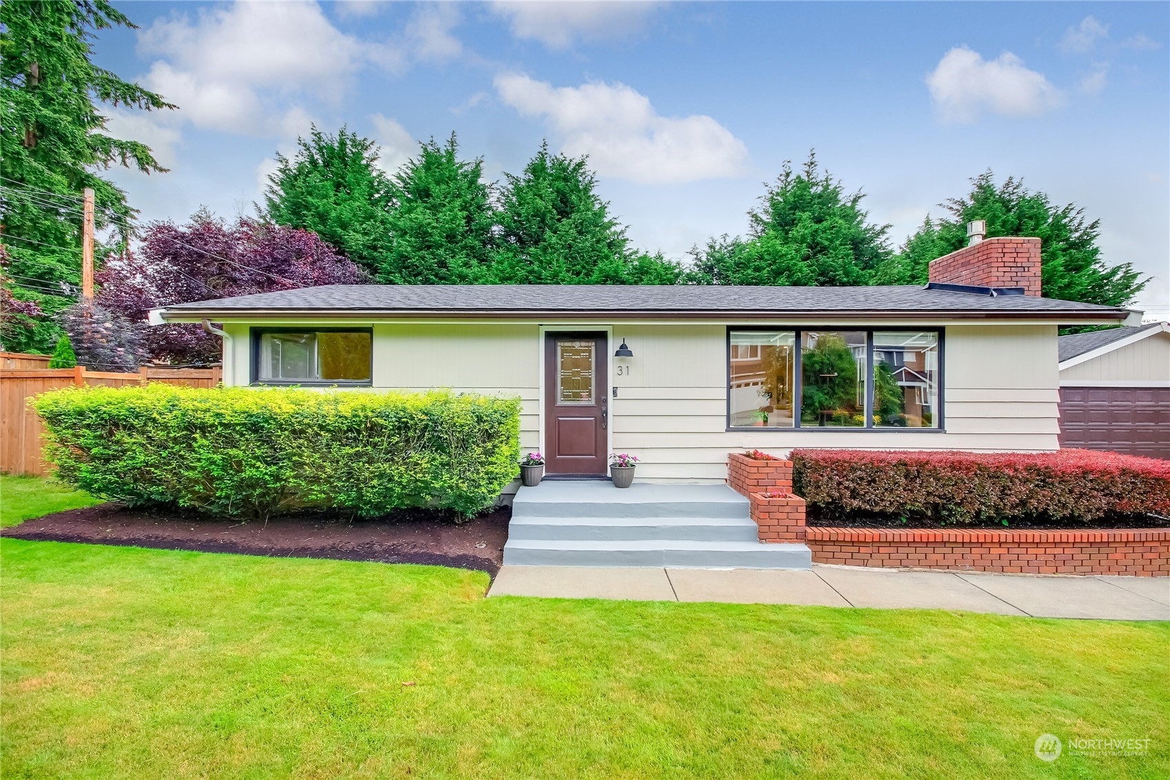 31 213th Street Southwest Bothell, WA 98021 - Photo 3 of 40 a front view of a house with a garden