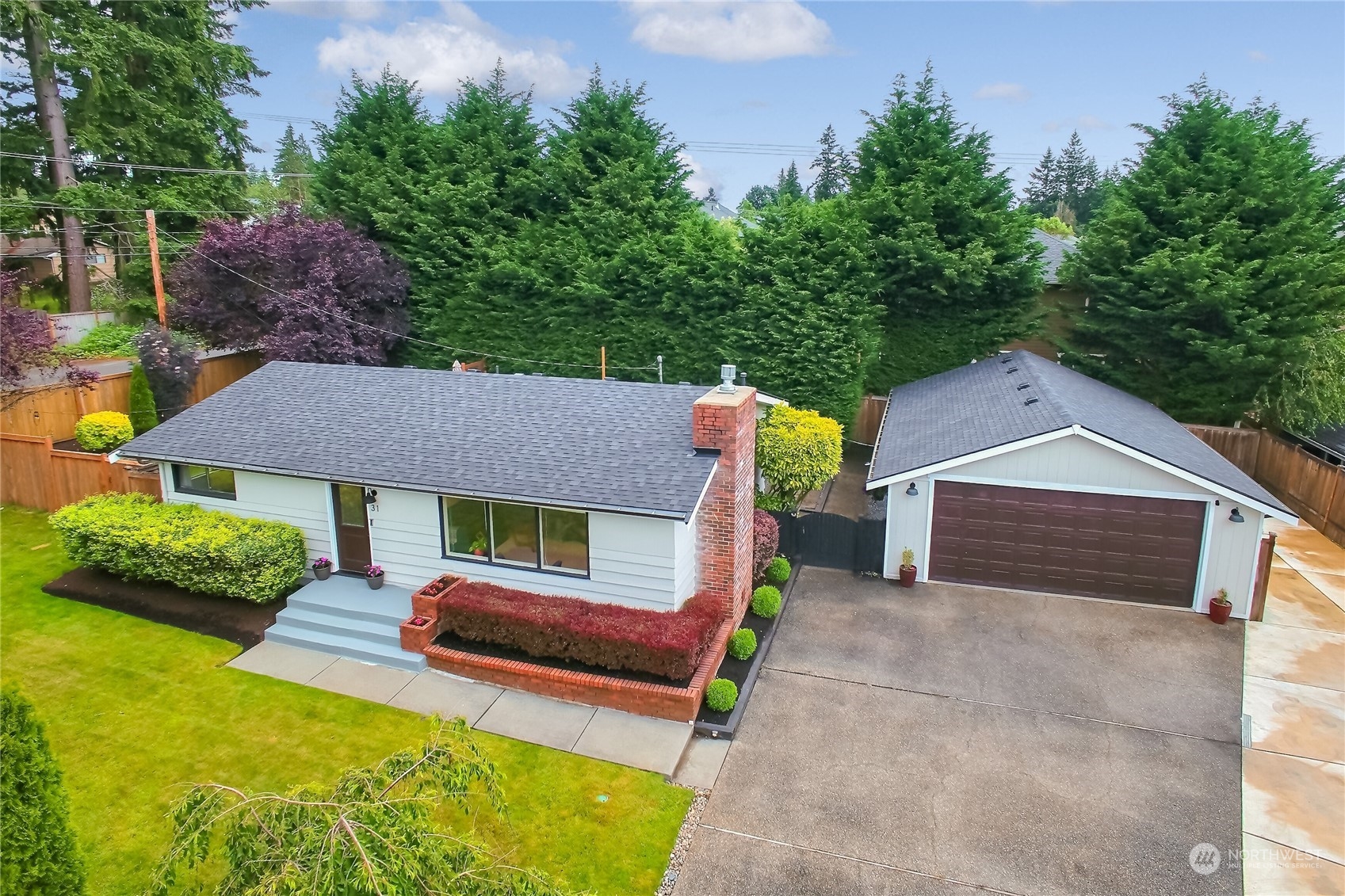 31 213th Street Southwest Bothell, WA 98021 - Photo 33 of 40 a front view of a house with a yard and garage