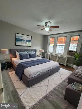 a bedroom with a large bed and a couch