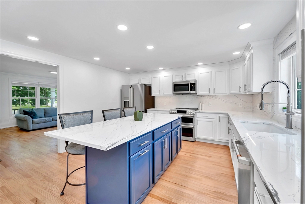 47 Fenwick Circle Methuen, MA 01844 - Photo 11 of 42 a large kitchen with stainless steel appliances granite countertop a stove a sink dishwasher and a refrigerator with wooden floor