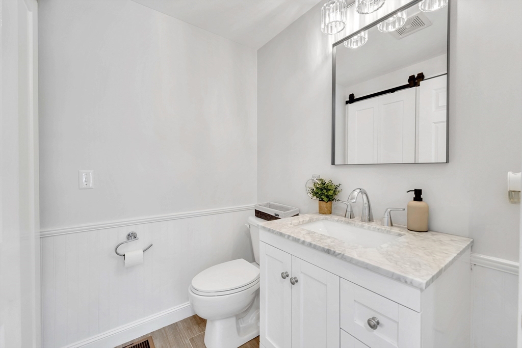 47 Fenwick Circle Methuen, MA 01844 - Photo 19 of 42 a bathroom with a granite countertop sink a toilet and mirror