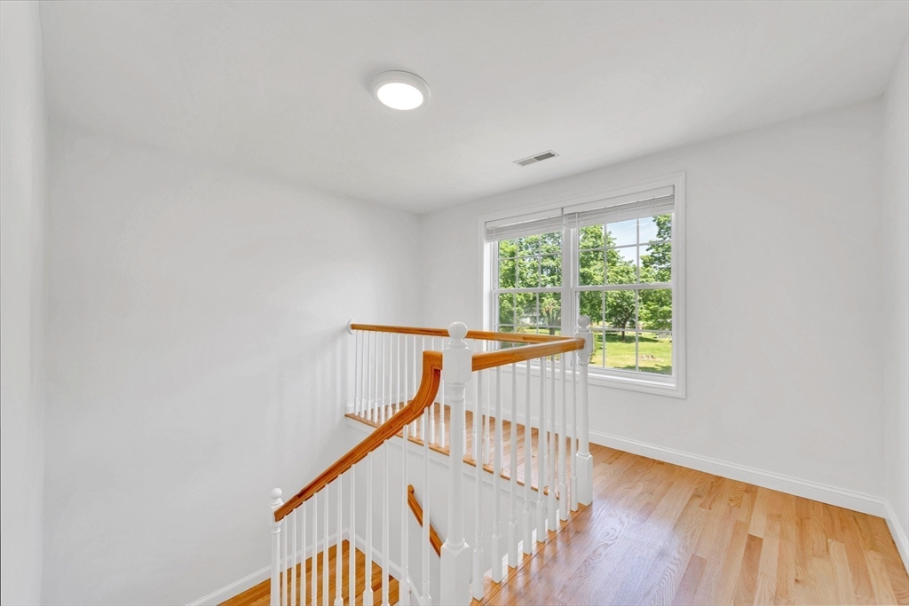 47 Fenwick Circle Methuen, MA 01844 - Photo 21 of 42 a view of a hallway with wooden floor and staircase
