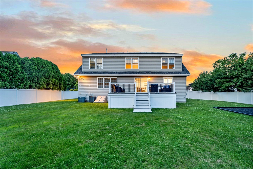 47 Fenwick Circle Methuen, MA 01844 - Photo 35 of 42 a front view of house with yard and trees in the background