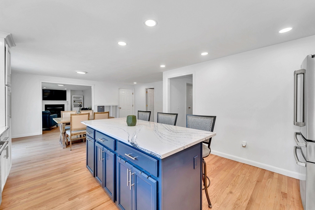 47 Fenwick Circle Methuen, MA 01844 - Photo 10 of 42 a large kitchen with kitchen island a sink a stove a refrigerator and a dining table with wooden floor