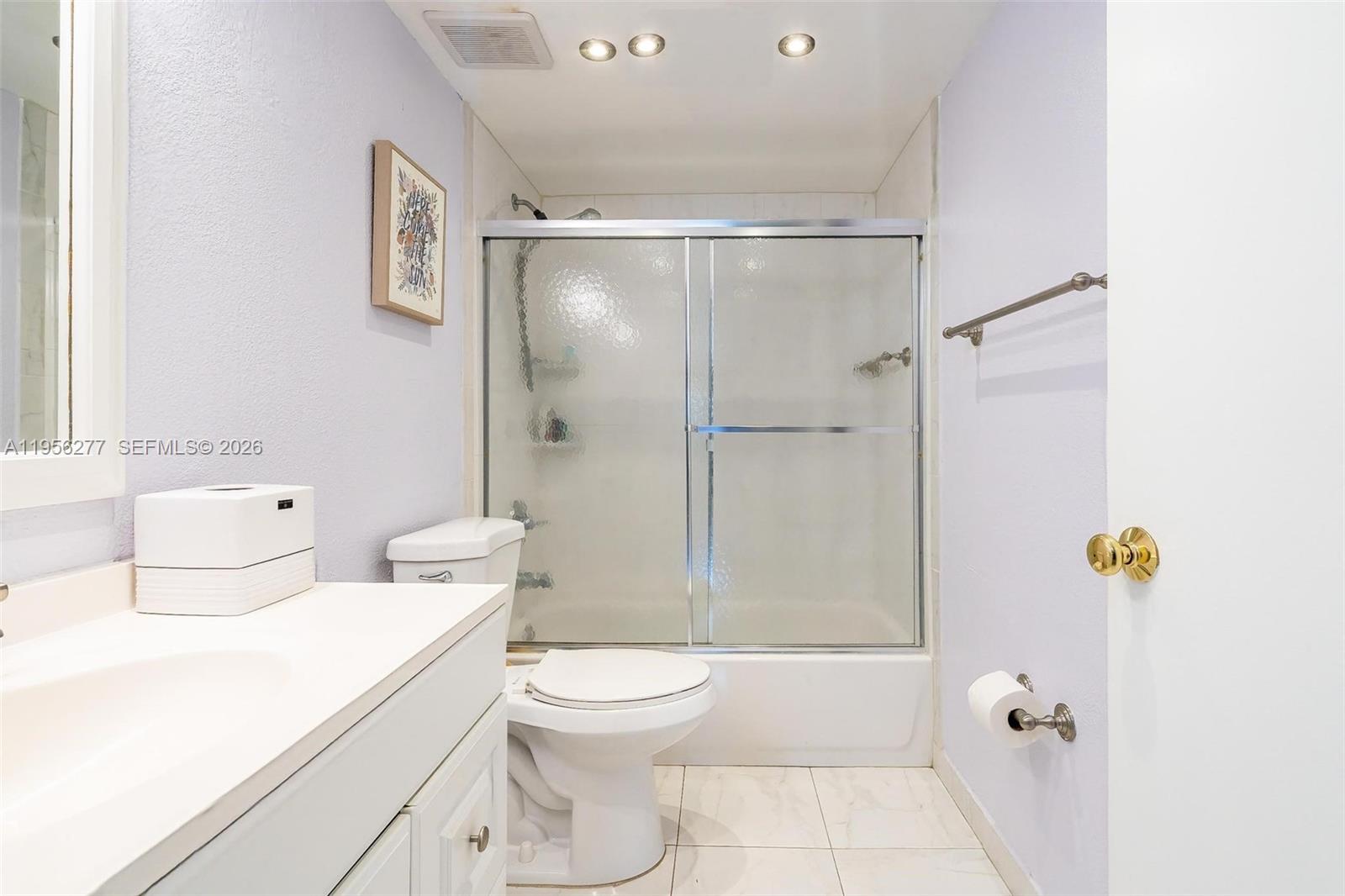 13810 Southwest 112th Street, Unit 102 Miami, FL 33186 - Photo 13 of 28 a bathroom with a toilet and shower