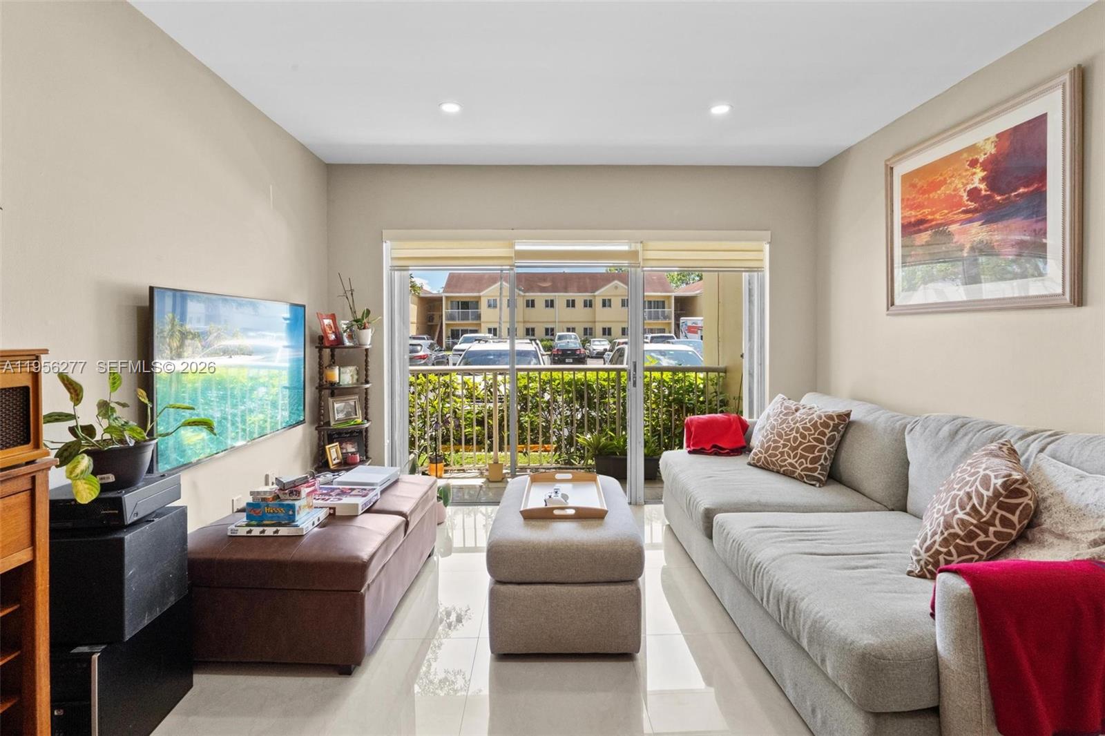 13810 Southwest 112th Street, Unit 102 Miami, FL 33186 - Photo 2 of 28 a living room with furniture and a large window