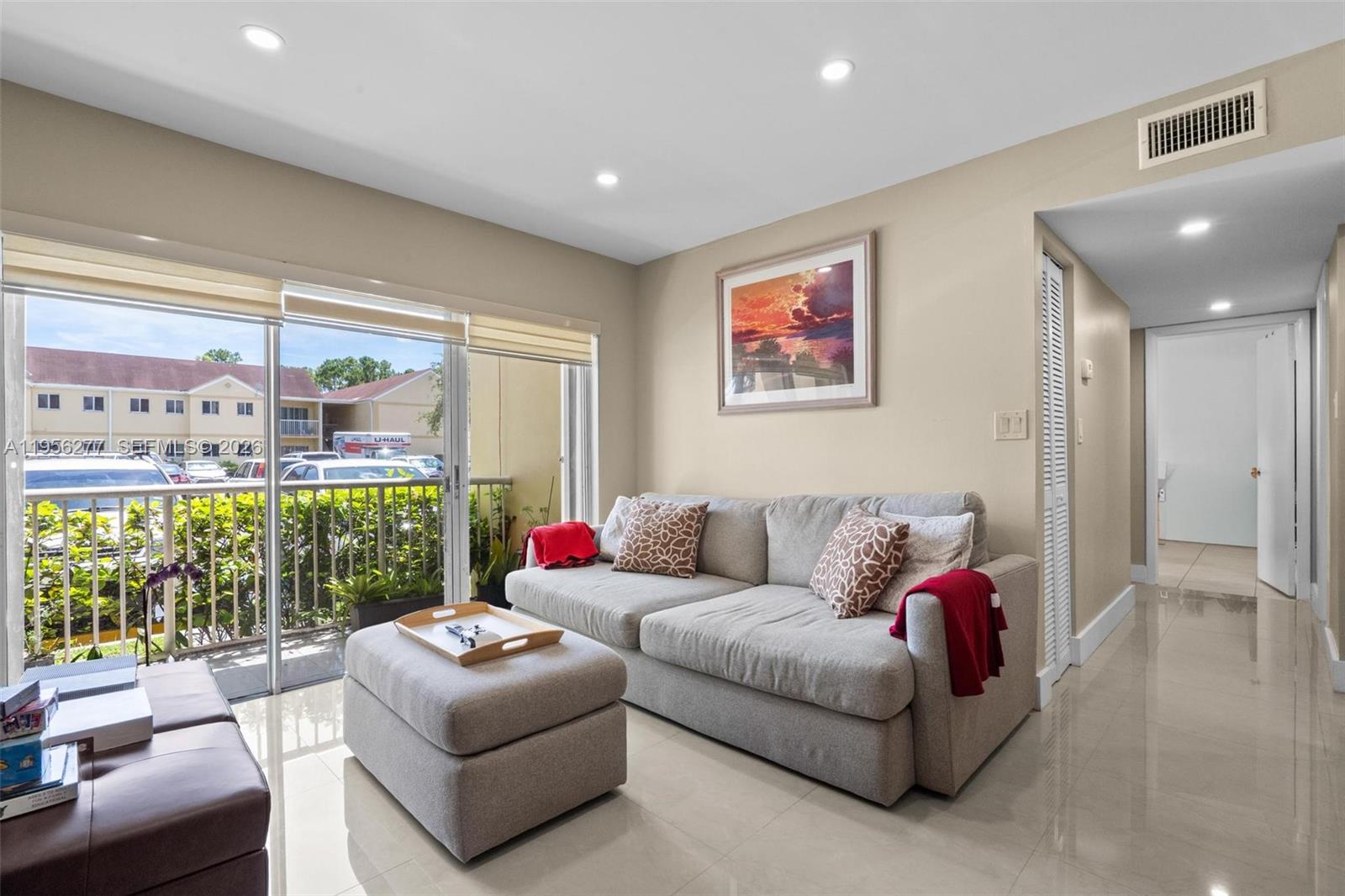 13810 Southwest 112th Street, Unit 102 Miami, FL 33186 - Photo 3 of 28 a living room with furniture and a large window