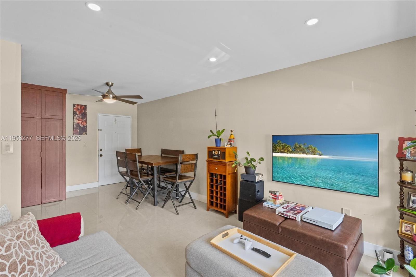 13810 Southwest 112th Street, Unit 102 Miami, FL 33186 - Photo 5 of 28 a living room with furniture and a flat screen tv