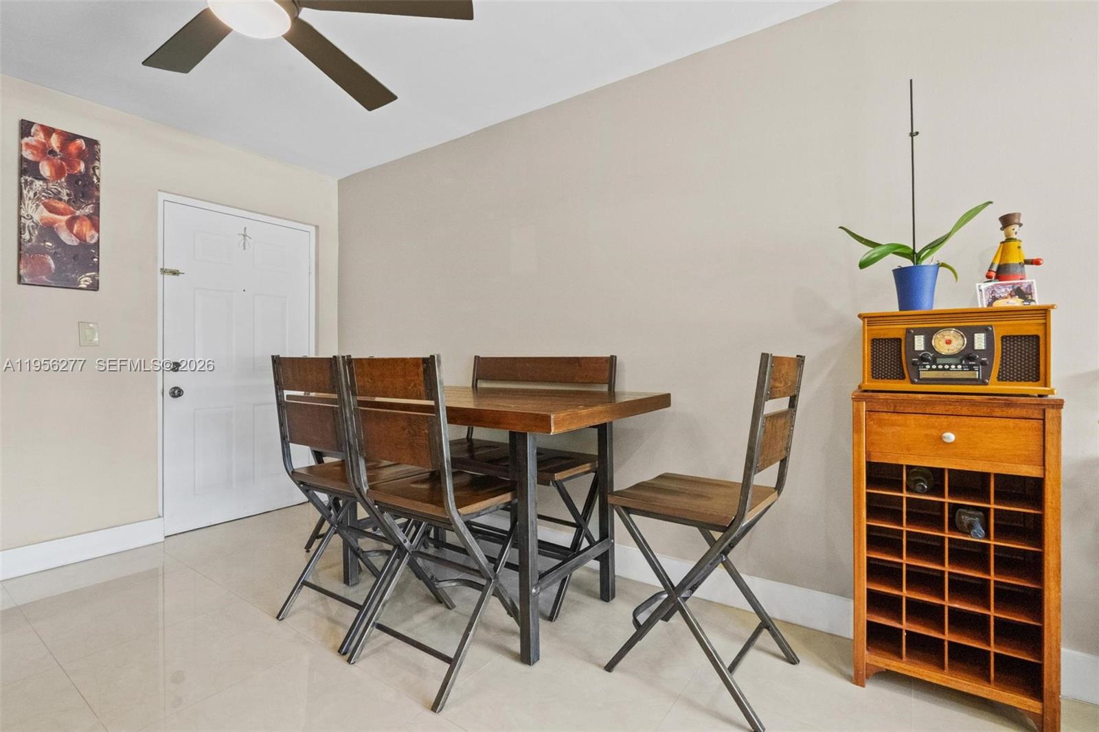 13810 Southwest 112th Street, Unit 102 Miami, FL 33186 - Photo 7 of 28 a view of a dining room with furniture and wooden floor