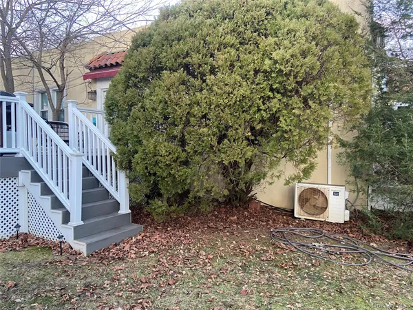 a backyard of a house with table and chairs