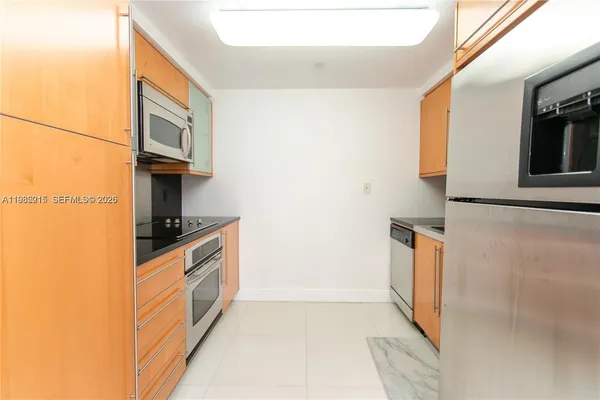 a kitchen with stainless steel appliances a stove and a microwave