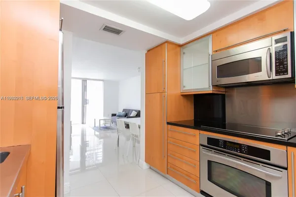 a kitchen with stainless steel appliances a refrigerator and cabinets