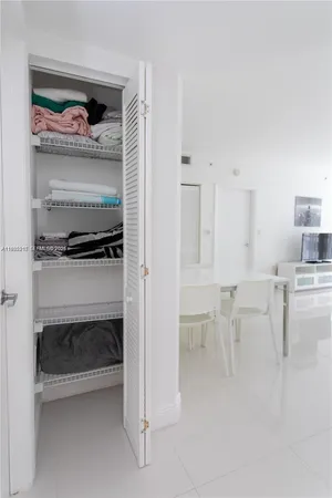 a spacious bedroom with a bed and glass door