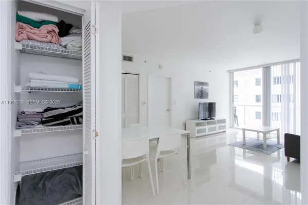 a view of a chair and table in a big room