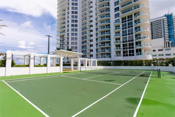 an outdoor sitting area with furniture and garden