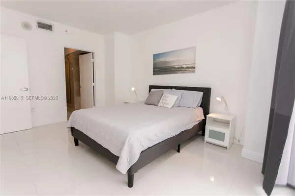 a bedroom with a bed and a chair
