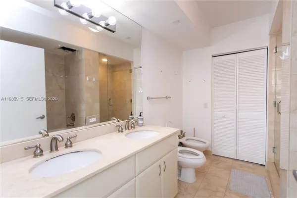 a bathroom with a granite countertop sink a toilet and a mirror