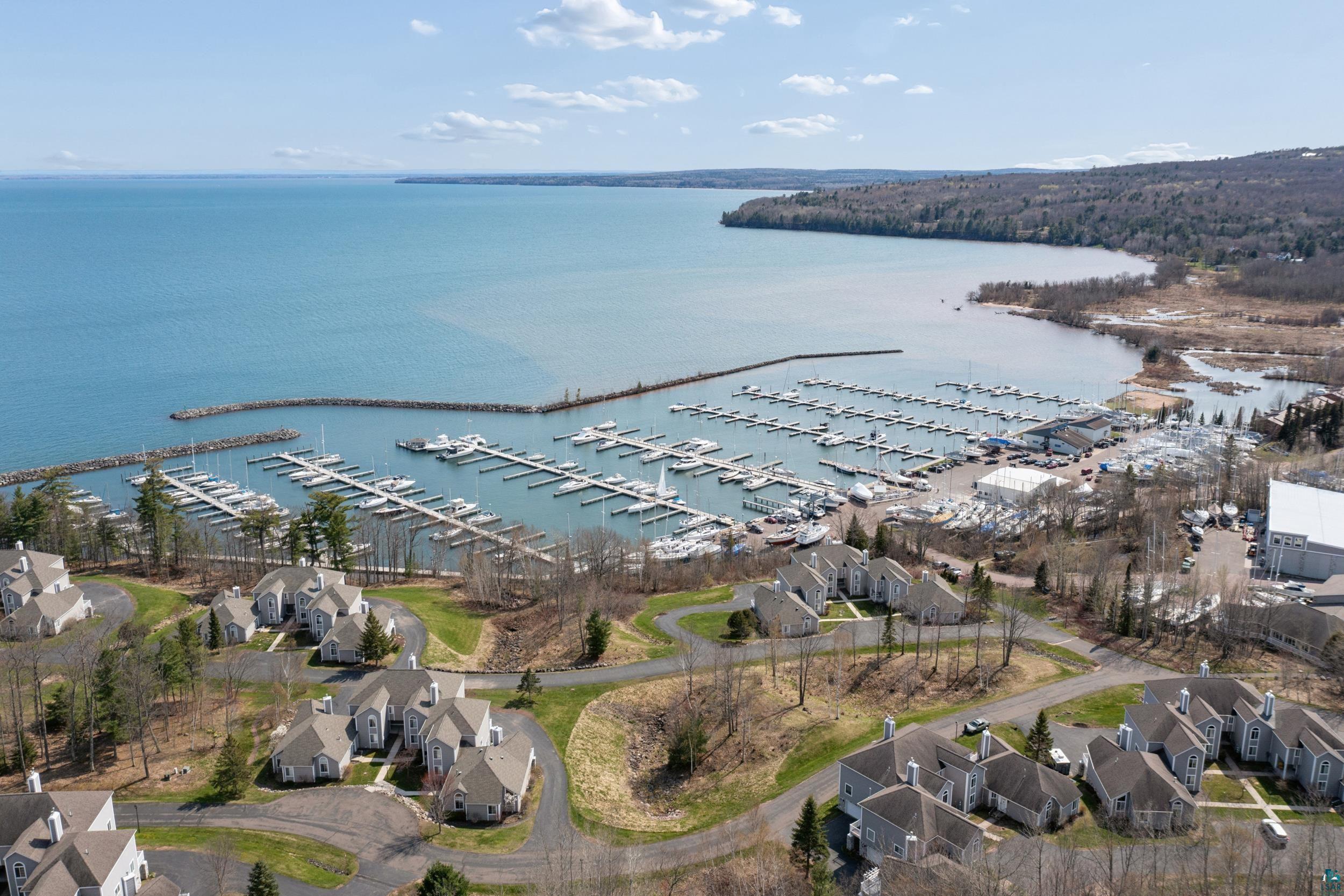 34590 Bay View Road, Unit 801 Bayfield, WI 54814 - Photo 34 of 36 Aerial perspective showcasing waterfront properties surrounding a marina with multiple boat slips