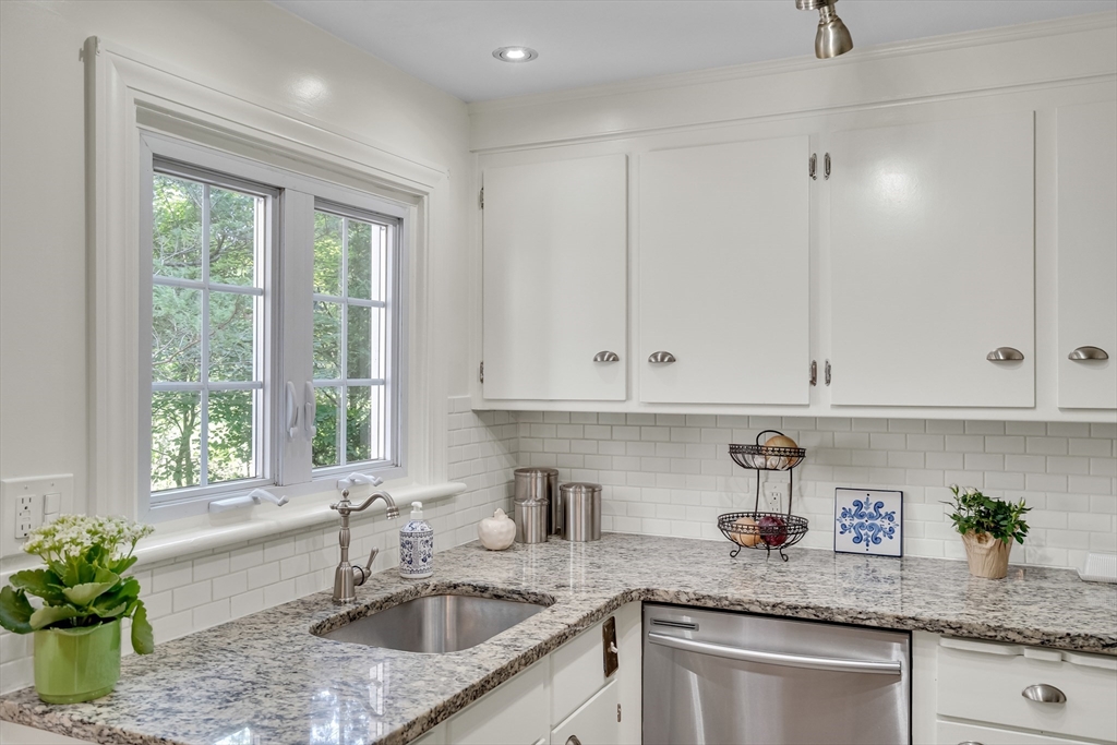 357 Lincoln Street Lexington, MA 02421 - Photo 11 of 29 a kitchen with granite countertop a sink window and cabinets