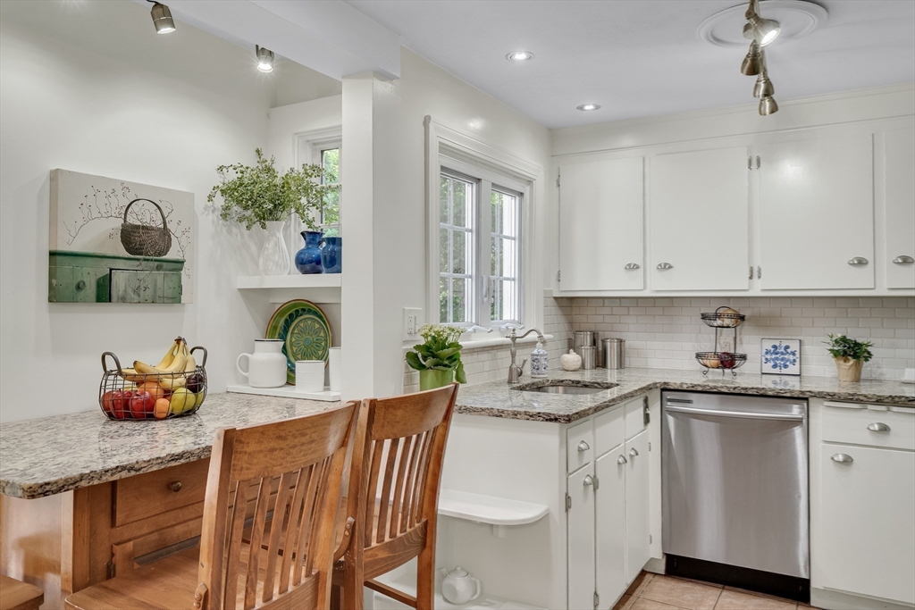 357 Lincoln Street Lexington, MA 02421 - Photo 12 of 29 a kitchen that has a lot of cabinets a sink and wooden floor