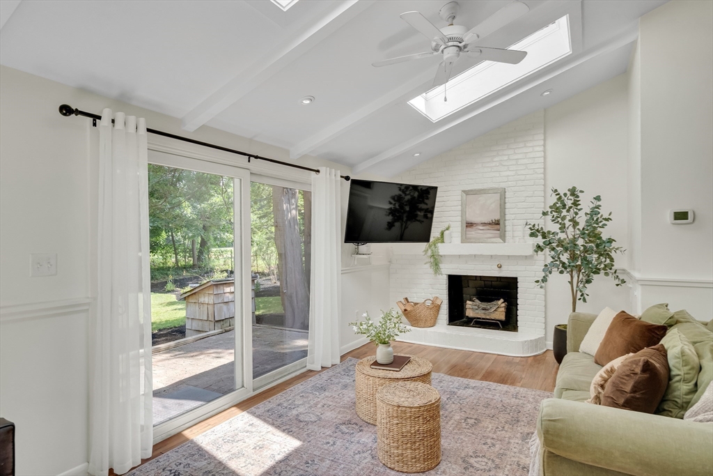 357 Lincoln Street Lexington, MA 02421 - Photo 14 of 29 a living room with furniture a flat screen tv and a fireplace
