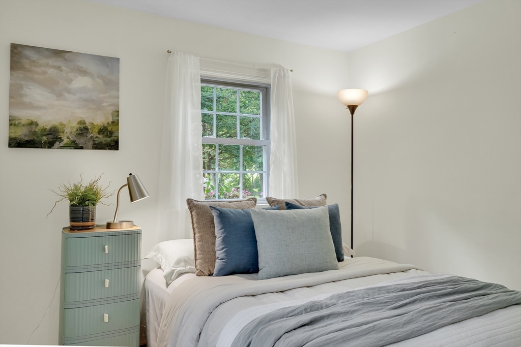 357 Lincoln Street Lexington, MA 02421 - Photo 18 of 29 a bedroom with a bed and a potted plant