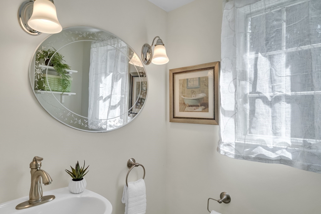 357 Lincoln Street Lexington, MA 02421 - Photo 20 of 29 a bathroom with a mirror and a sink
