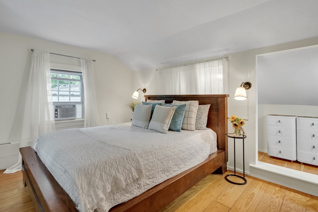 357 Lincoln Street Lexington, MA 02421 - Photo 24 of 29 a large bed sitting in a bedroom next to a window and a lamp