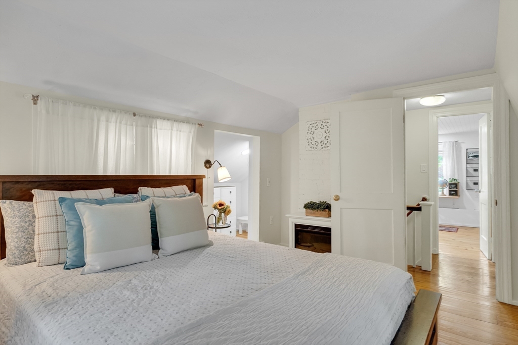 357 Lincoln Street Lexington, MA 02421 - Photo 25 of 29 a spacious bedroom with a bed and wooden floor