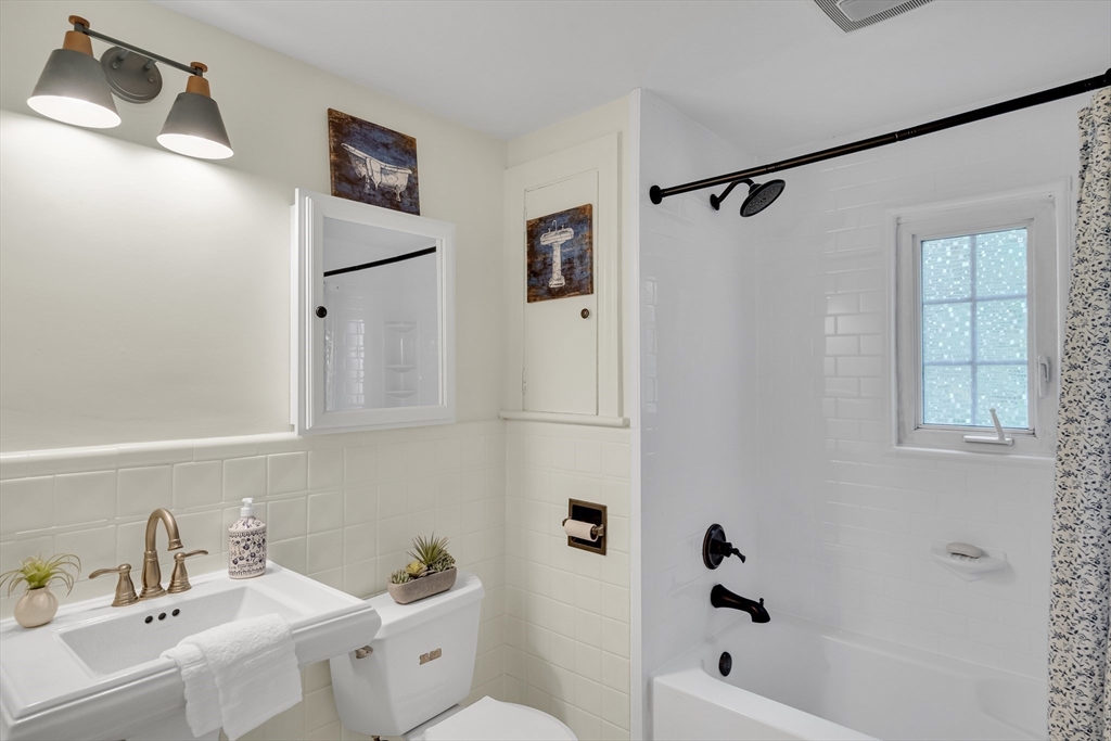 357 Lincoln Street Lexington, MA 02421 - Photo 7 of 29 a white bath tub sitting next to a white sink and vanity