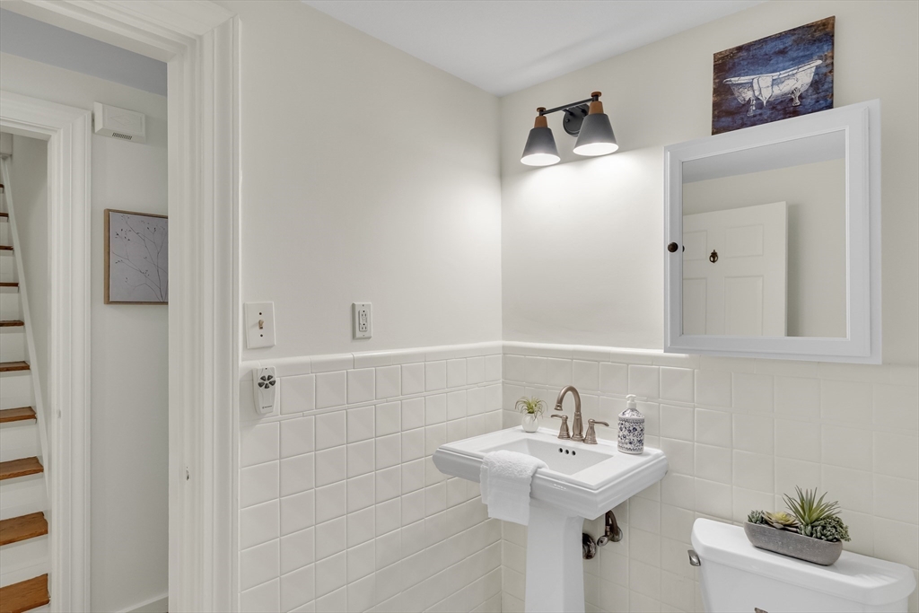 357 Lincoln Street Lexington, MA 02421 - Photo 8 of 29 a bathroom with a sink a mirror and a shower