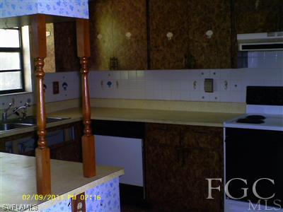 18277 Apple Road Fort Myers, FL 33967 - Photo 5 of 8 a kitchen with a sink and cabinets