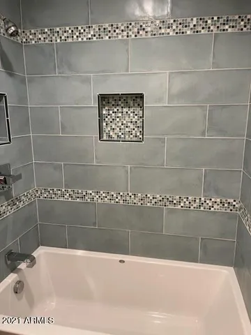 a bathroom with a bathtub and shower