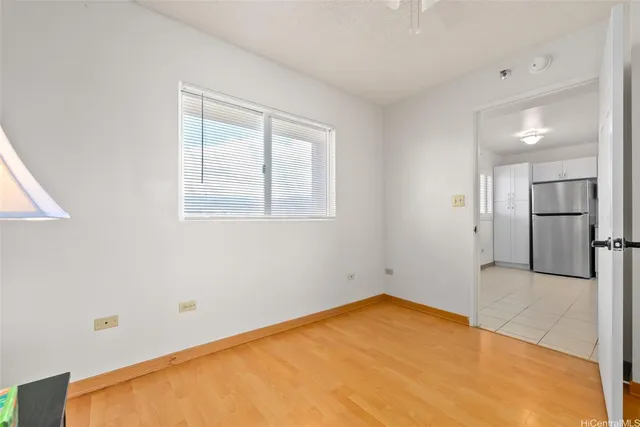 a view of empty room with a kitchen