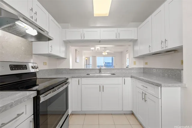 a kitchen with white cabinets appliances and a sink
