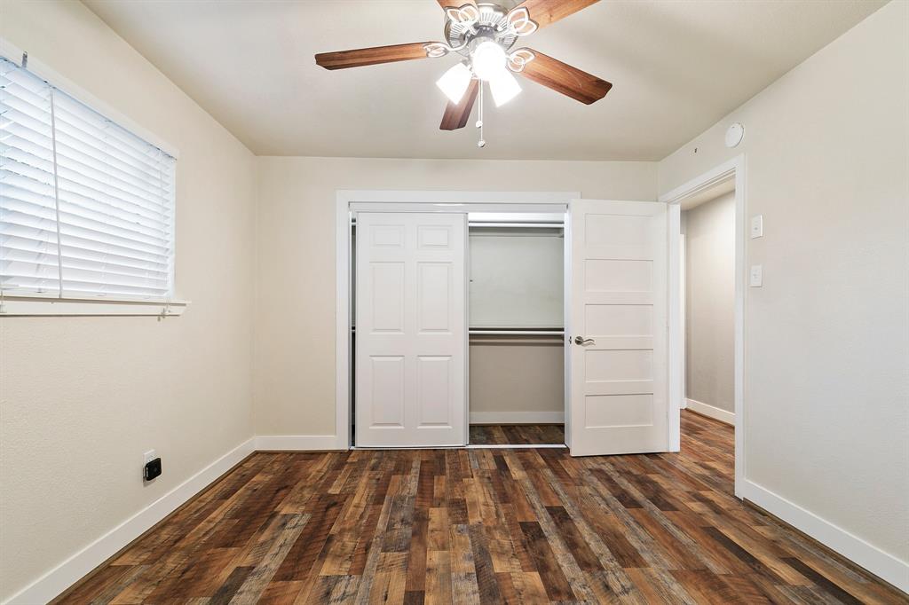 909 North Dove Road Grapevine, TX 76051 - Photo 16 of 30 Primary bedroom Room featuring wood-finish flooring, white baseboards, and a ceiling fan with light fixture