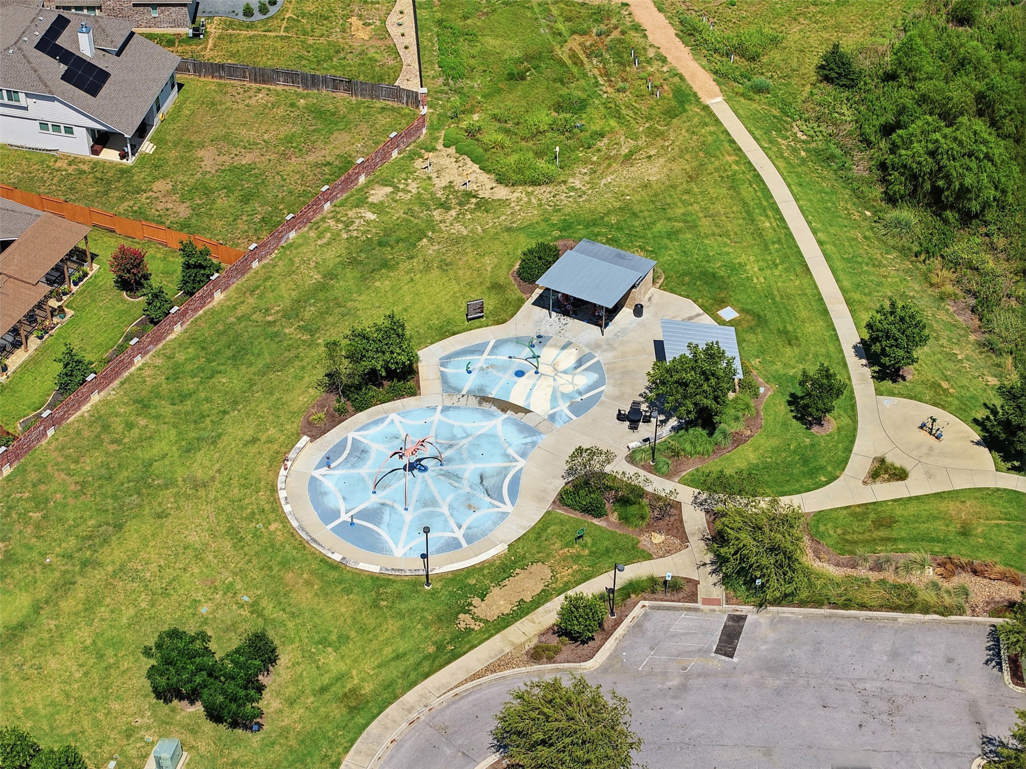 3101 Rabbit Creek Drive Georgetown, TX 78626 - Photo 37 of 38 An aerial perspective reveals a vibrant community splash pad and scenic walking trails Just a short walk away - located at the end of the street from this home.