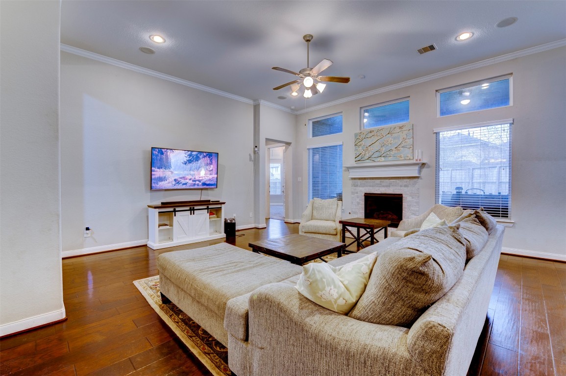 6242 Avon Landing Lane Spring, TX 77379 - Photo 11 of 42 a living room with furniture a fireplace and a flat screen tv