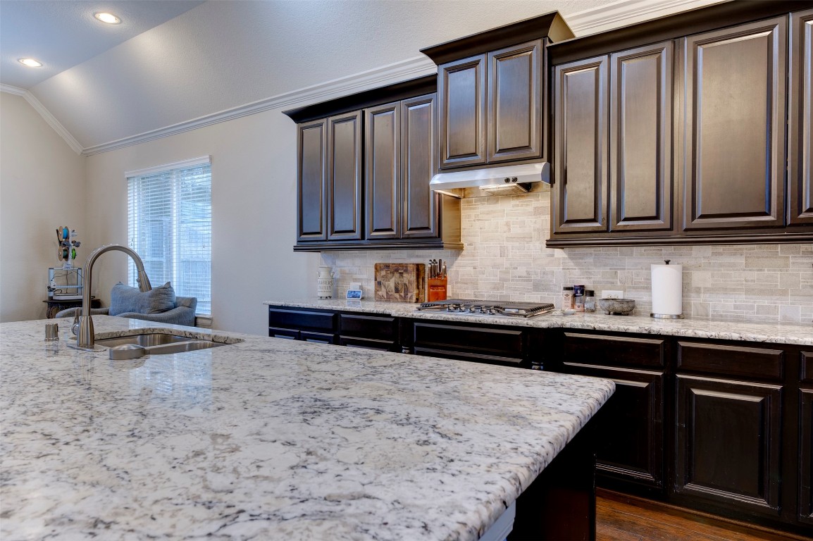 6242 Avon Landing Lane Spring, TX 77379 - Photo 12 of 42 a kitchen with granite countertop wooden cabinets and a granite counter tops