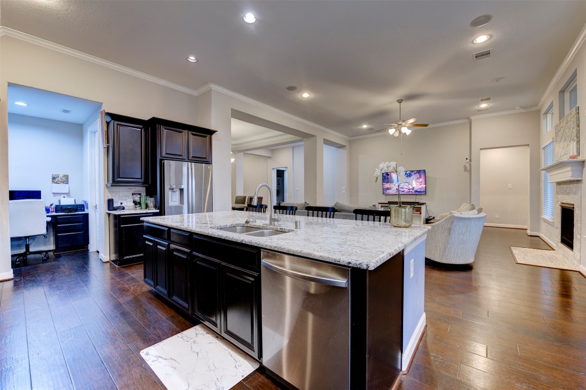 6242 Avon Landing Lane Spring, TX 77379 - Photo 14 of 42 a large kitchen with stainless steel appliances kitchen island granite countertop a large island in the center