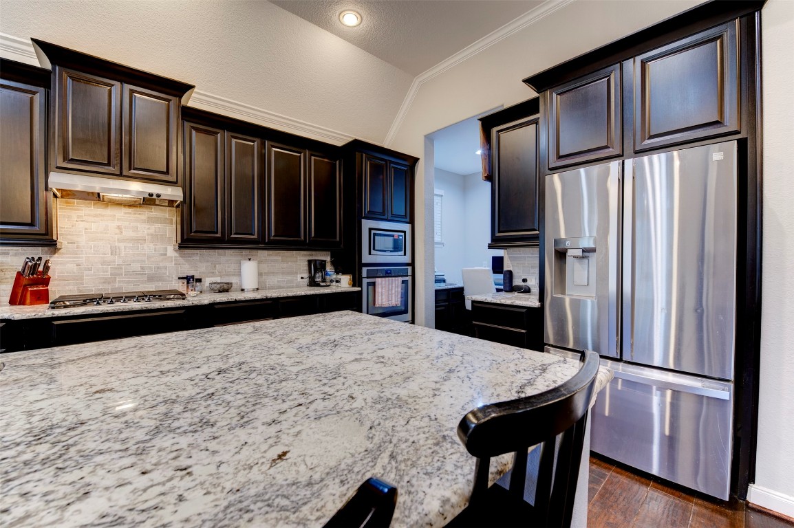 6242 Avon Landing Lane Spring, TX 77379 - Photo 15 of 42 a kitchen with stainless steel appliances granite countertop a refrigerator stove microwave and sink