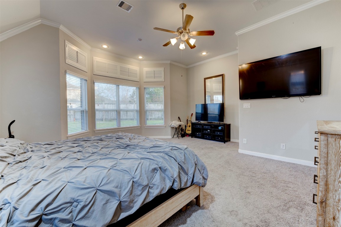 6242 Avon Landing Lane Spring, TX 77379 - Photo 20 of 42 a bedroom with a large bed and a flat screen tv