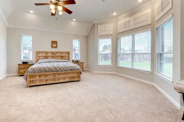 a white toilet sitting next to a white wall