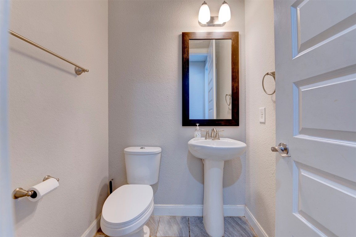 6242 Avon Landing Lane Spring, TX 77379 - Photo 26 of 42 a bathroom with a toilet a sink and mirror